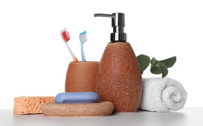 Photo of Bath accessories. Different personal care products and eucalyptus branch on table against white background