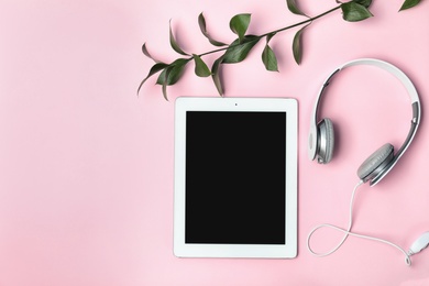 Photo of Flat lay composition with tablet, headphones and space for text on color background