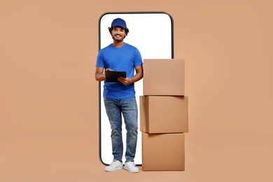 Image of Courier with stack of parcels and clipboard near huge smartphone on dark beige background. Delivery service
