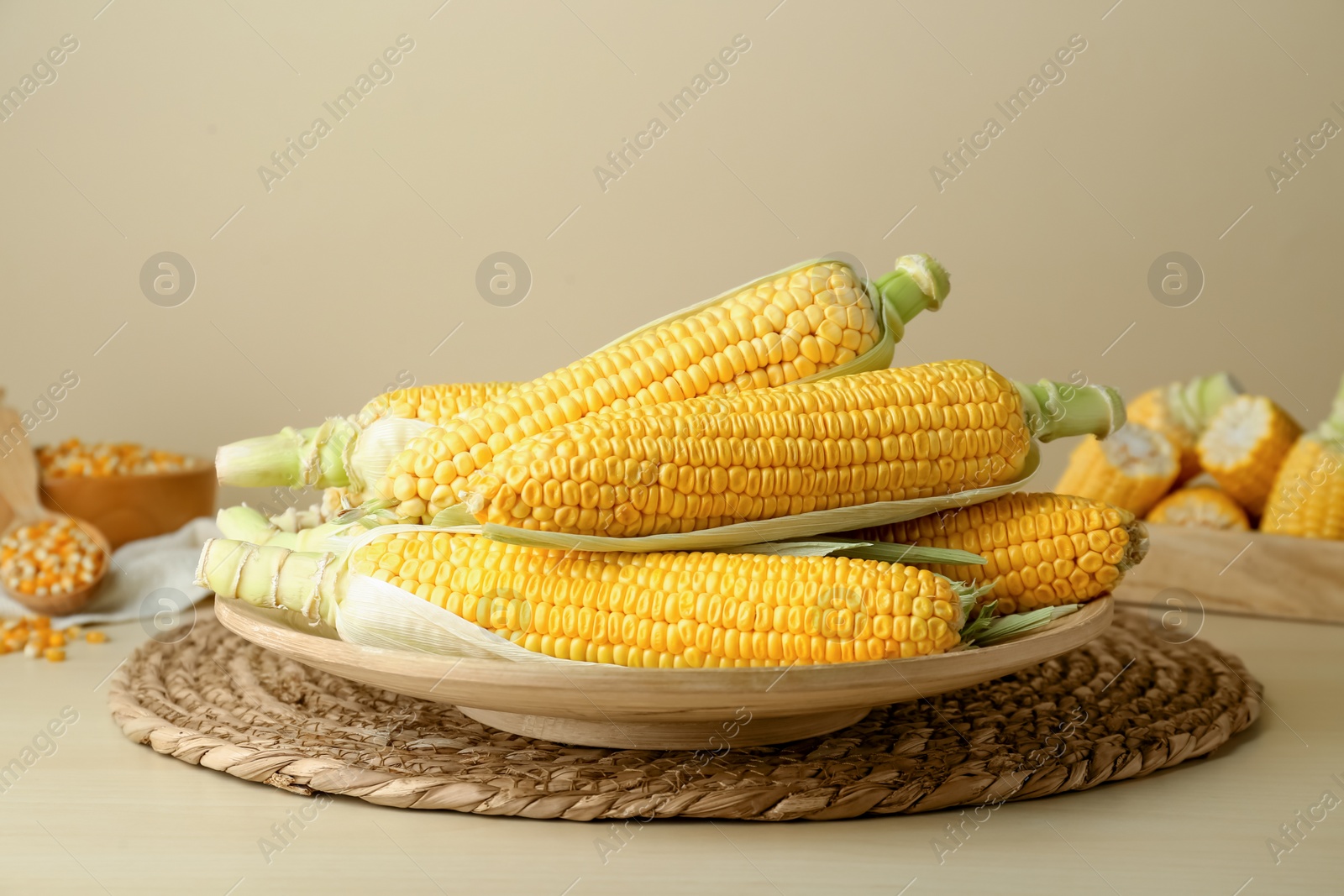 Photo of Tasty fresh corn cobs on wooden table