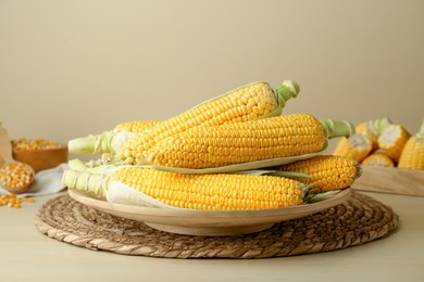 Tasty fresh corn cobs on wooden table