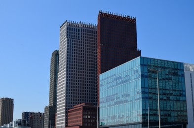 Exterior of beautiful modern buildings against blue sky