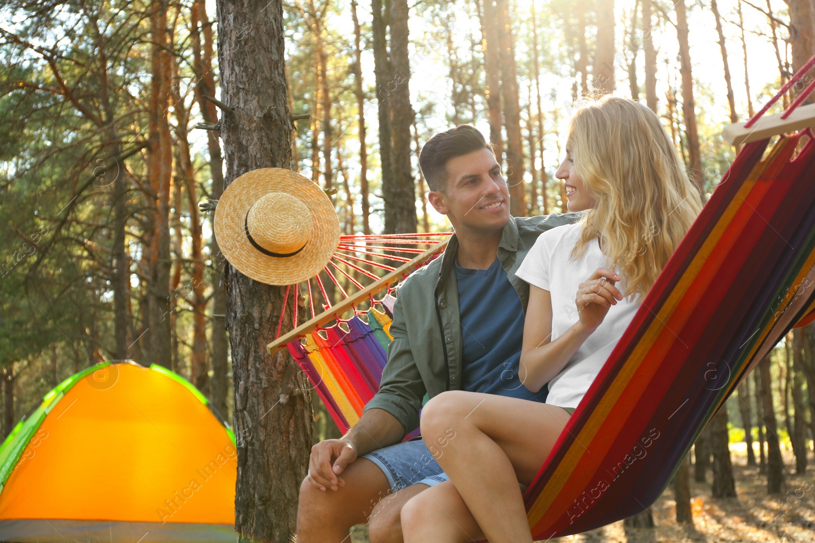 Photo of Couple resting in hammock outdoors on summer day