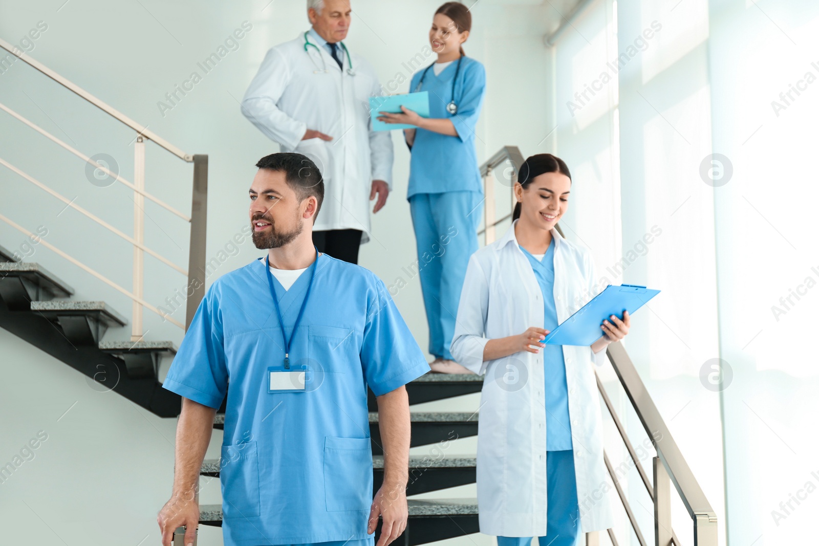 Photo of Group of doctors walking in clinic. Medical service