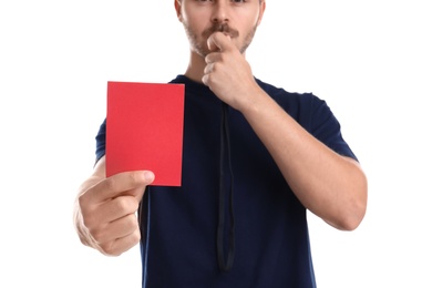 Photo of Football referee with whistle holding red card on white background, closeup