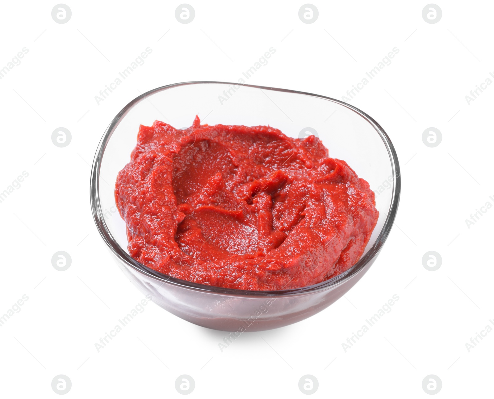 Photo of Glass bowl of tasty tomato paste isolated on white