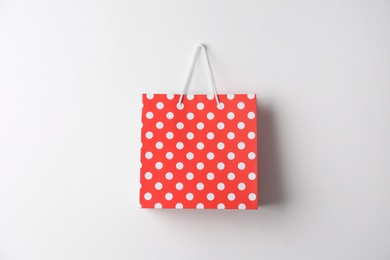 Photo of Paper shopping bag hanging on white wall