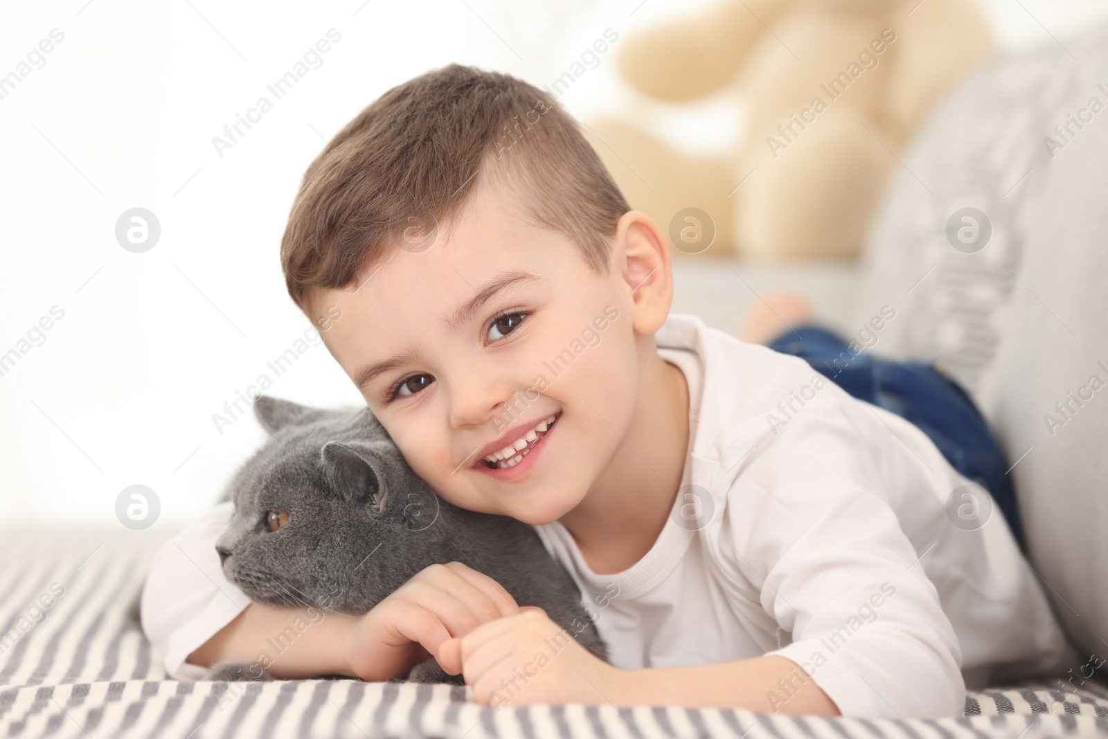 Photo of Cute little child with cat at home