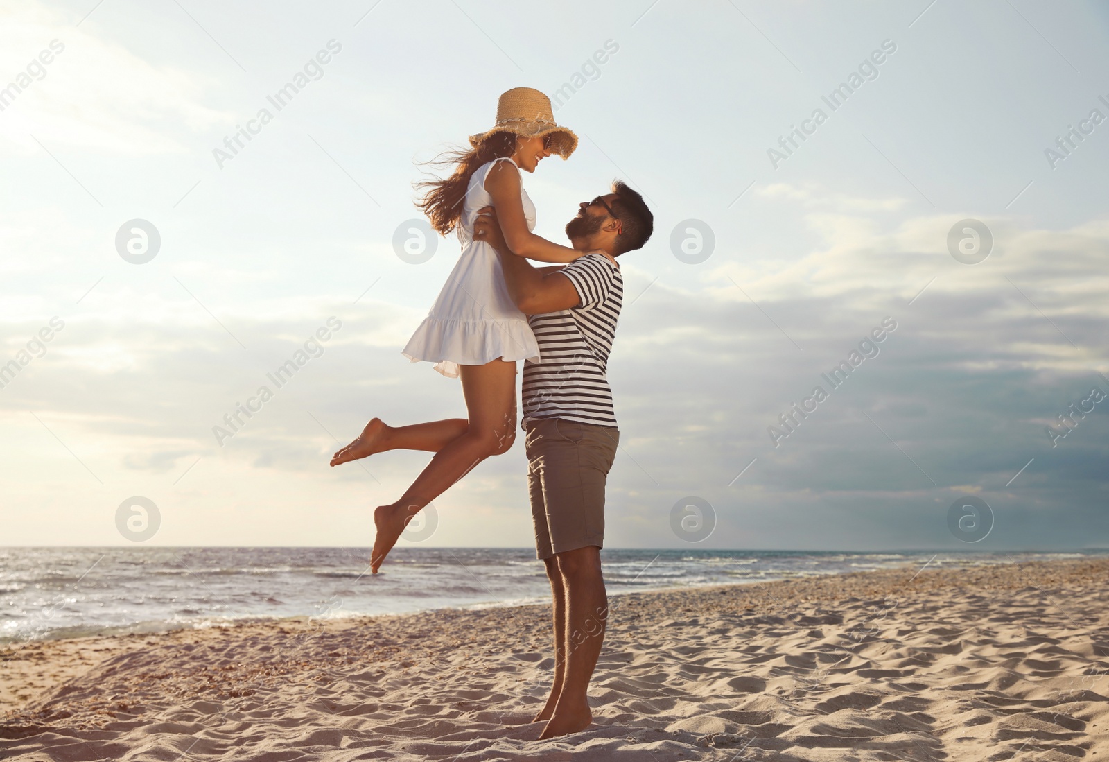 Photo of Lovely couple spending time together on beach