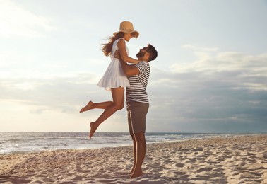 Photo of Lovely couple spending time together on beach