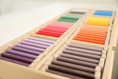 Wooden box with color tablets, closeup. Montessori toy