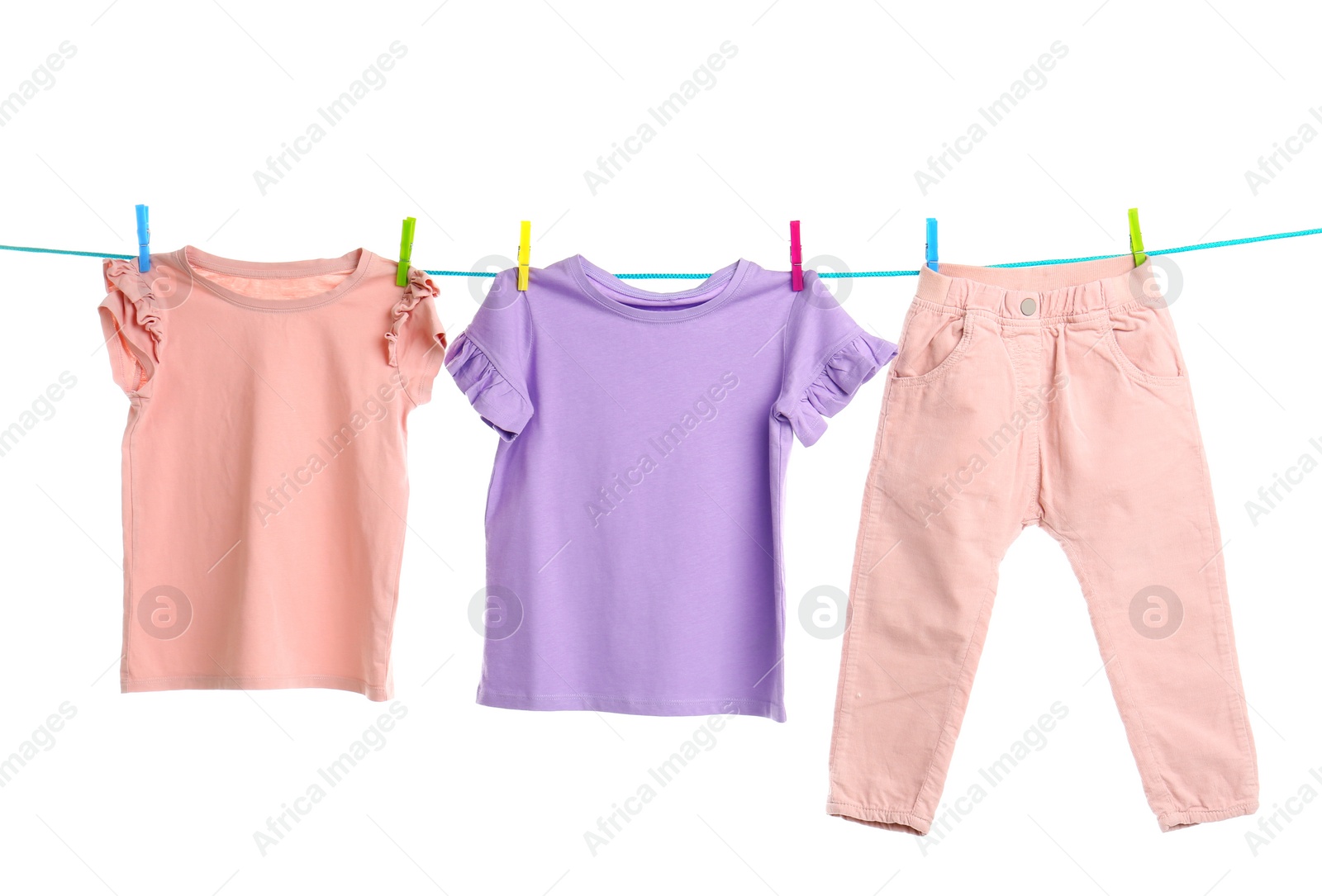 Photo of Child clothes on laundry line against white background