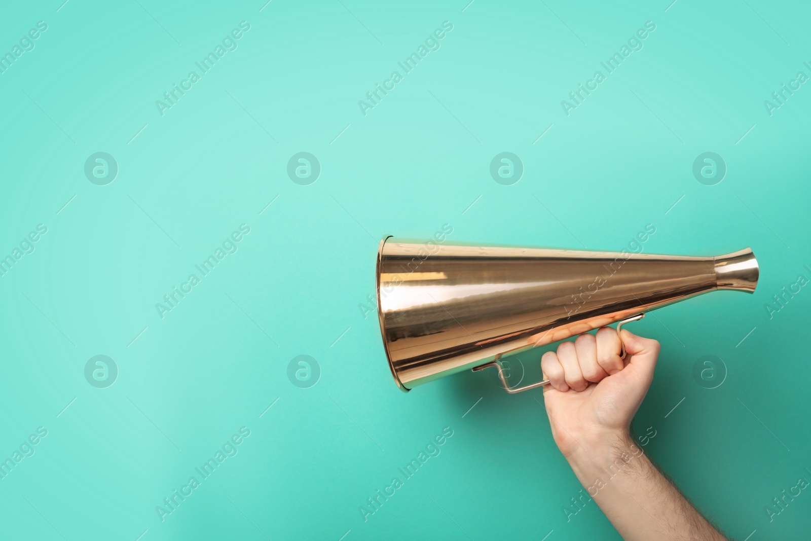 Photo of Man holding megaphone on color background