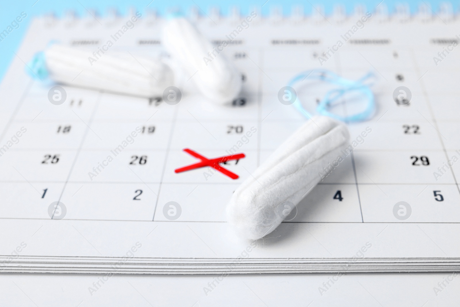 Photo of Tampons and calendar with marked date, closeup. Gynecological care