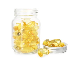 Photo of Bottle and pile of softgel capsules isolated on white