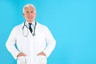 Photo of Portrait of senior doctor against blue background, space for text