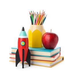 Bright toy rocket and school supplies on white background