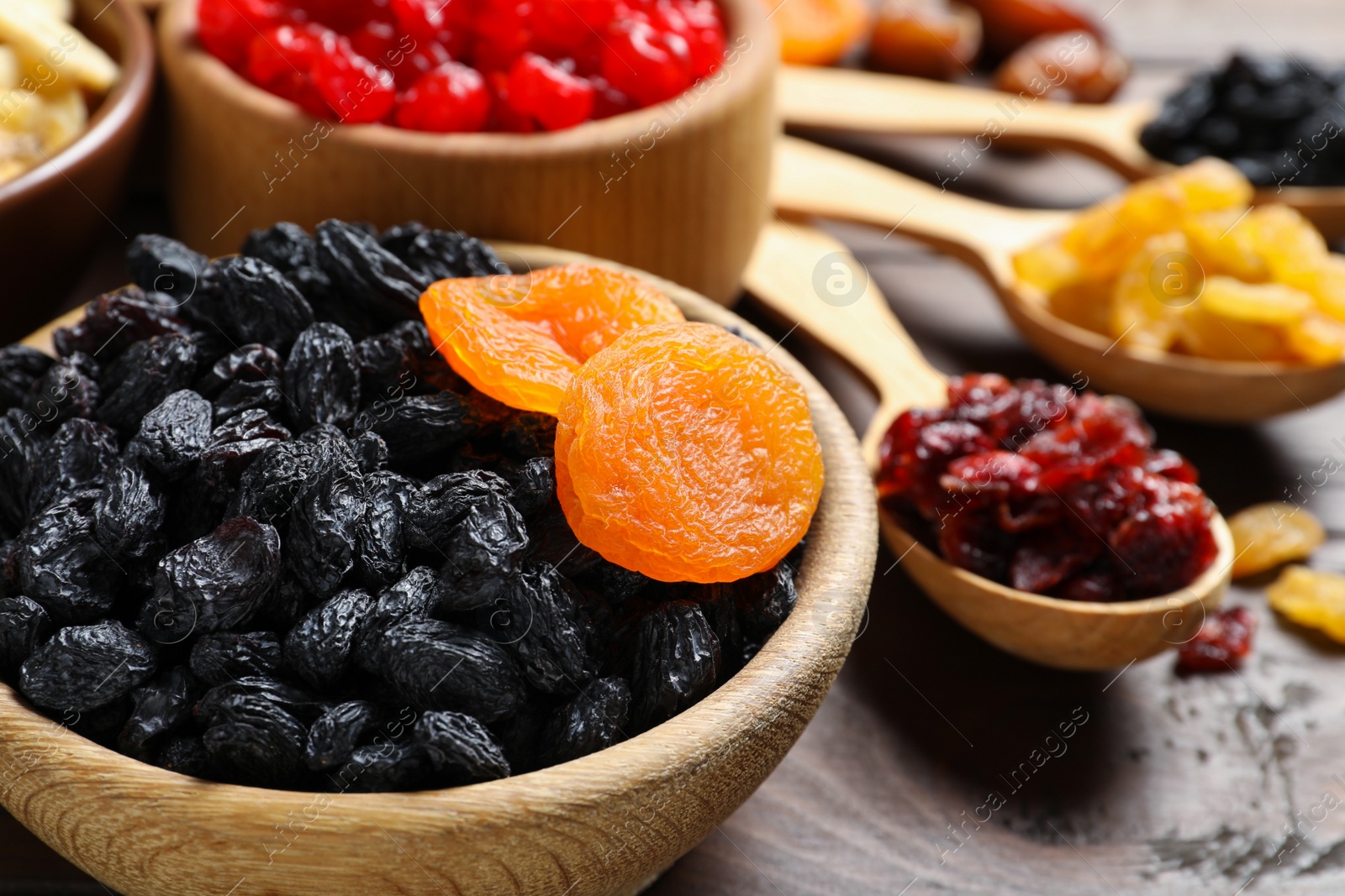 Photo of Composition with different dried fruits on wooden background, closeup. Healthy lifestyle