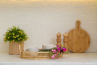 Photo of Blurred view of modern kitchen with houseplant