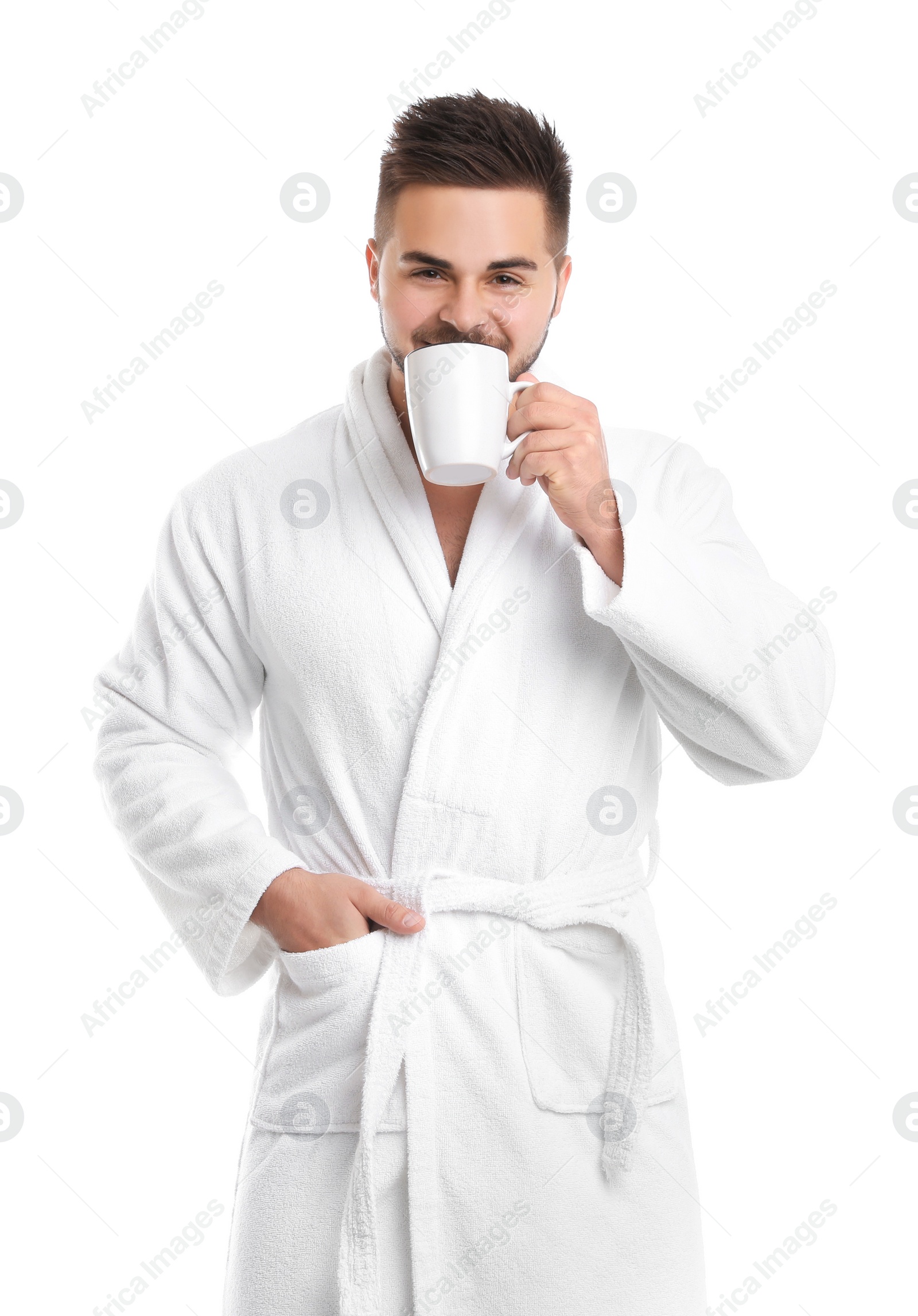 Photo of Handsome man in bathrobe drinking coffee on white background