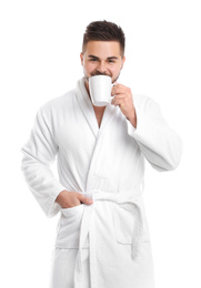 Photo of Handsome man in bathrobe drinking coffee on white background