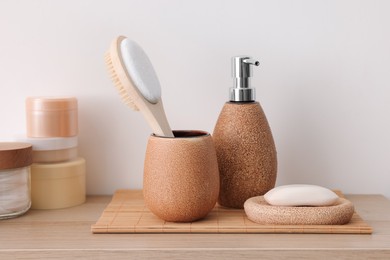 Different bath accessories and personal care products on wooden table