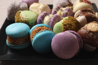 Photo of Delicious colorful macarons on plate, closeup view