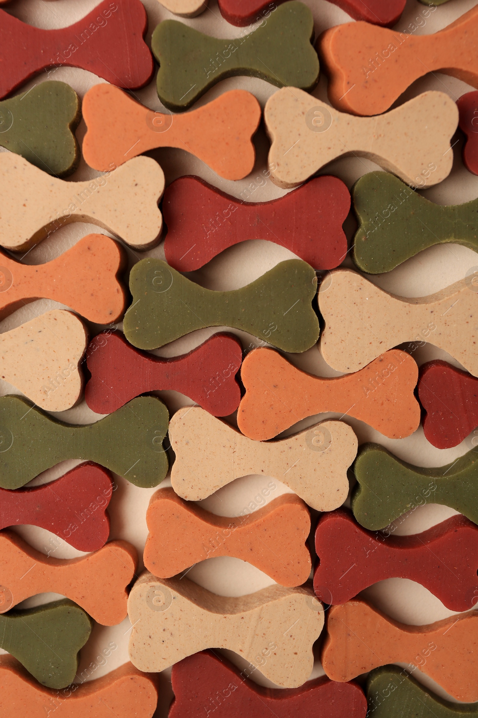 Photo of Flat lay composition with many bone shaped vitamins for pets on beige background