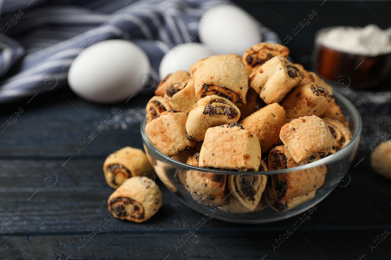 Photo of Tasty sweet cookies with poppy seeds on wooden table