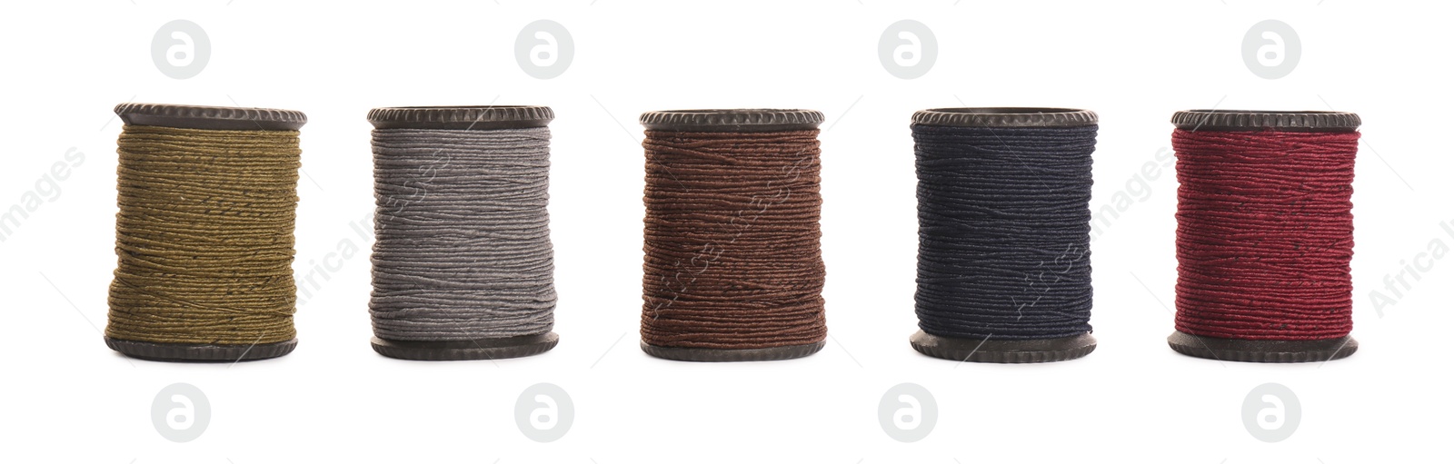 Photo of Set of colorful sewing threads on white background