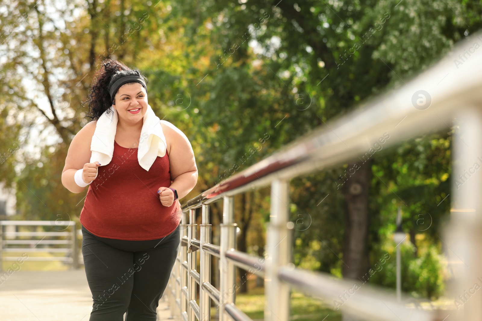 Photo of Beautiful overweight woman running outdoors. Fitness lifestyle