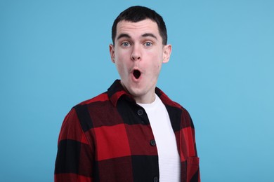 Photo of Portrait of surprised man on light blue background