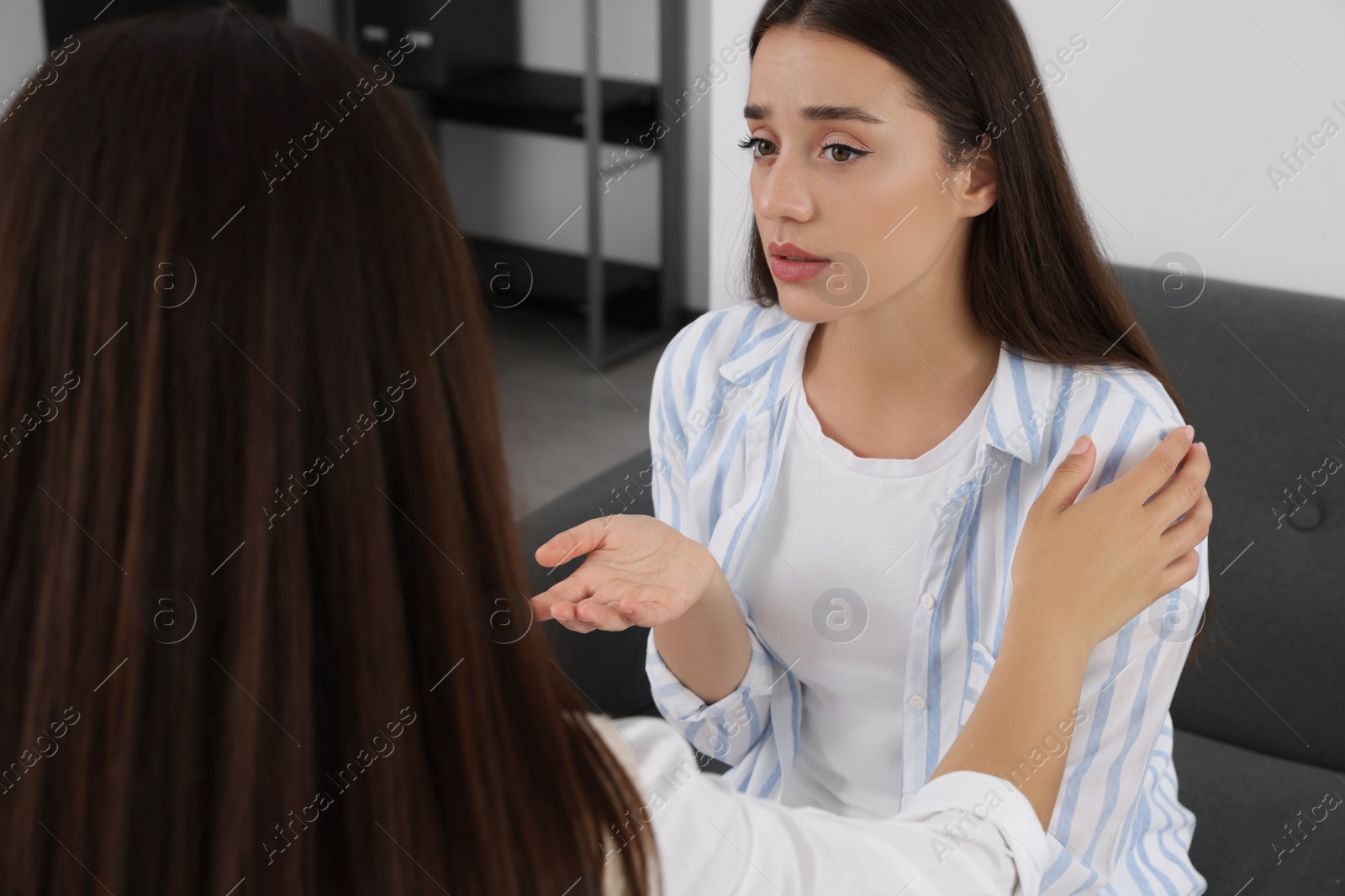 Photo of Professional psychologist working with young woman in office