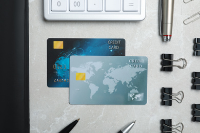 Photo of Flat lay composition with credit cards, calculator and stationery on light grey marble background