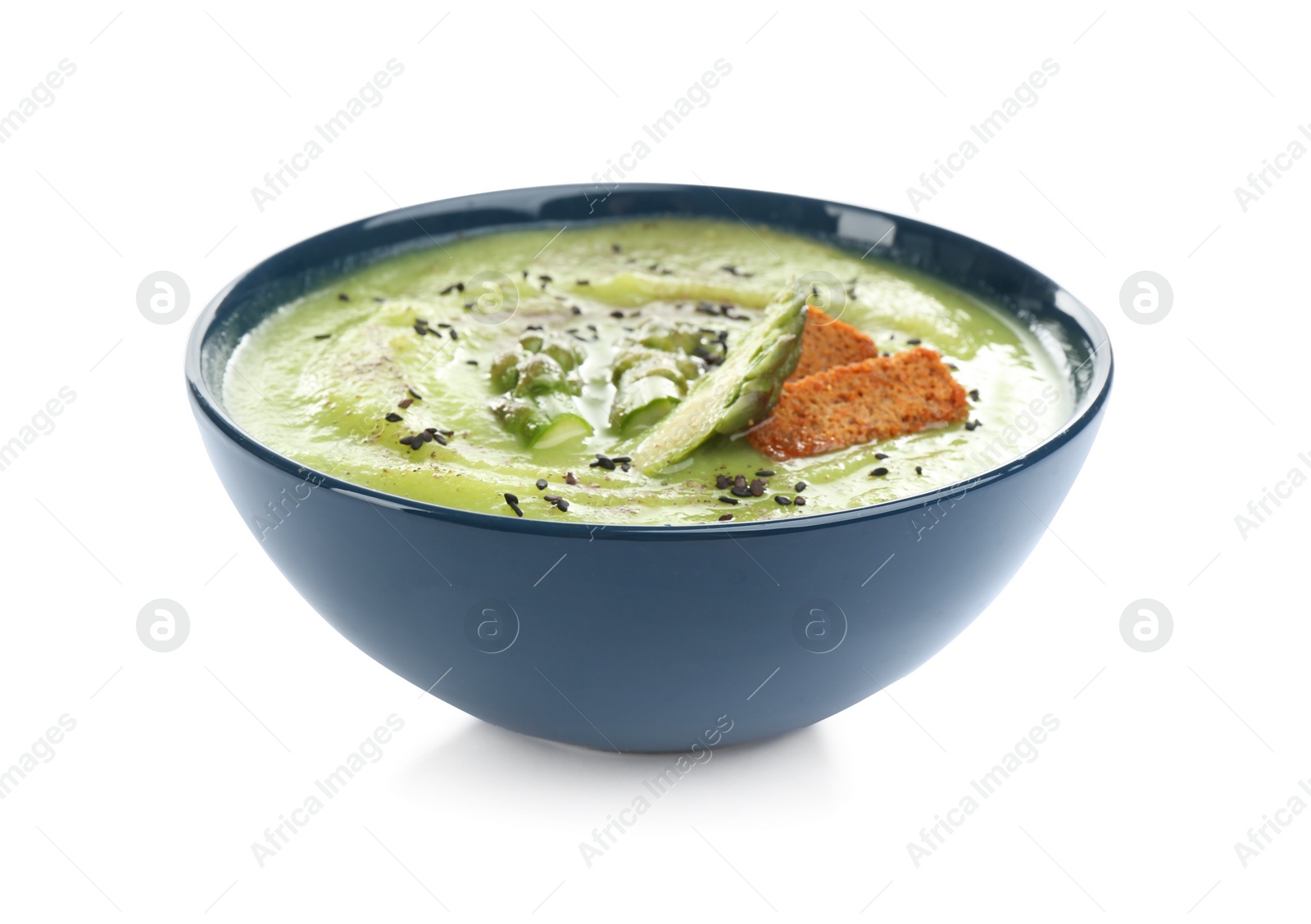 Photo of Delicious asparagus soup with rusks and sesame seeds isolated on white