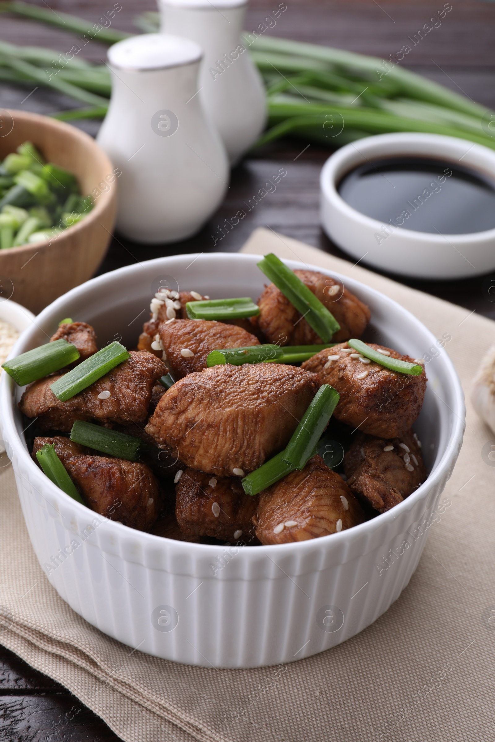Photo of Tasty soy sauce and roasted meat on table, closeup