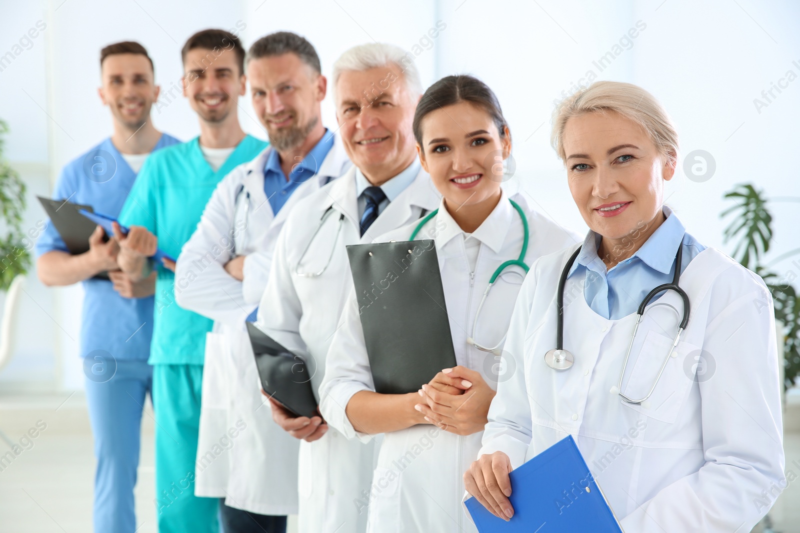 Photo of Group of doctors in uniform at clinic. Cardiology conference