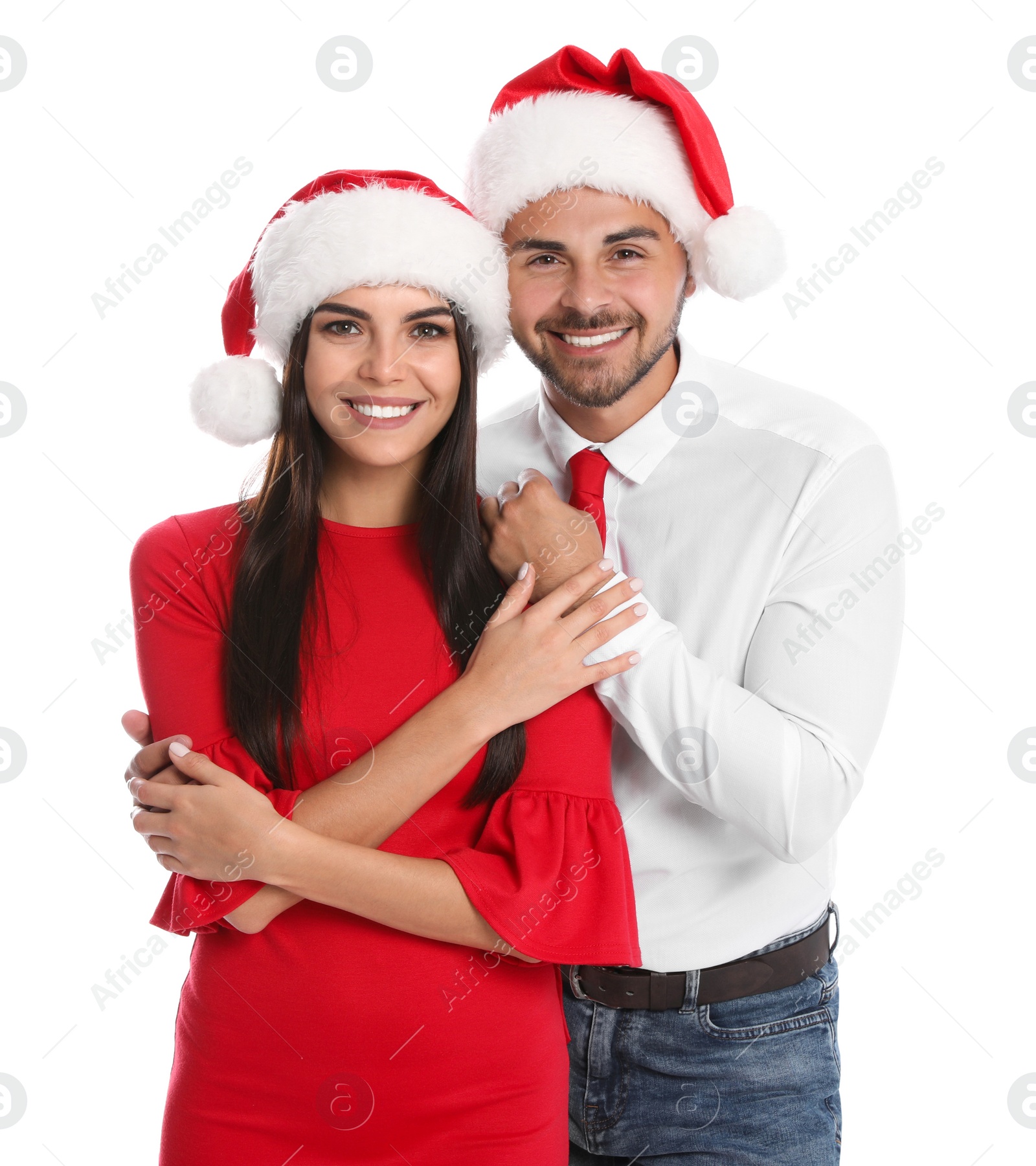 Photo of Lovely young couple in Santa hats on white background. Christmas celebration