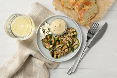 Photo of Flat lay composition with delicious grilled zucchini slices on white wooden table