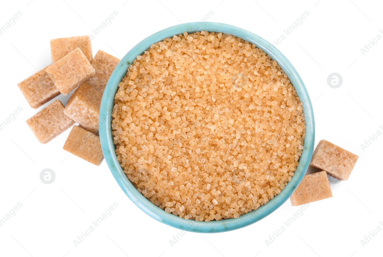 Photo of Different types of brown sugar and bowl isolated on white, top view