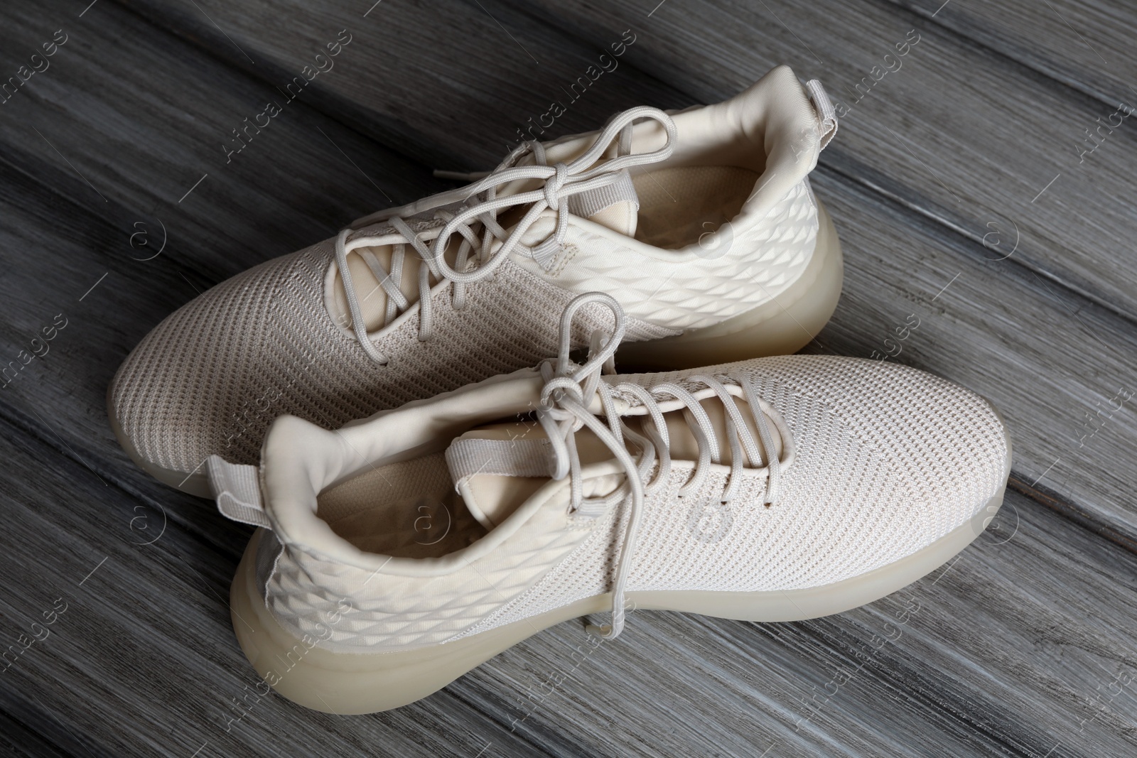 Photo of Pair of stylish shoes with laces on wooden background