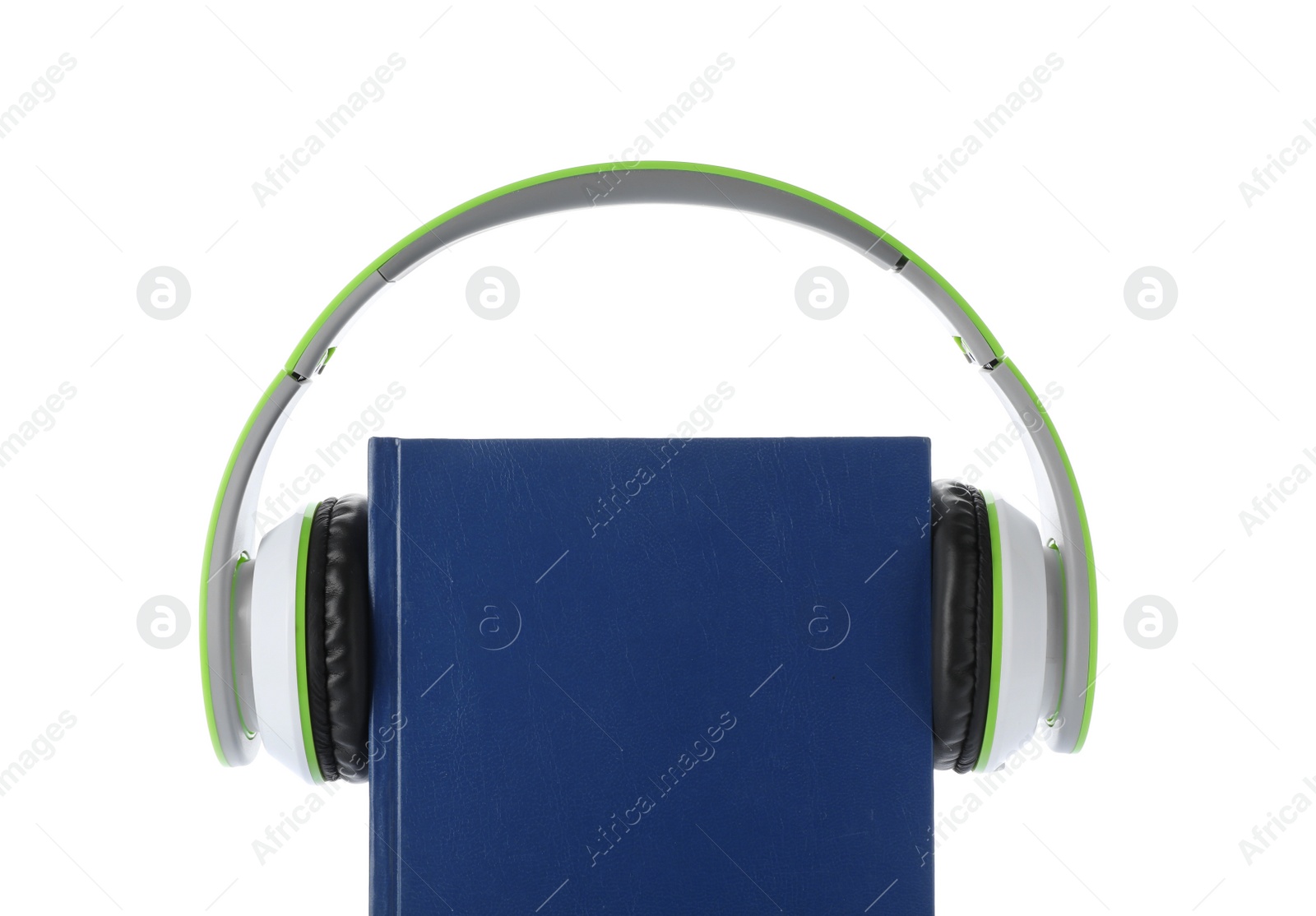 Photo of Modern headphones with hardcover book on white background, closeup