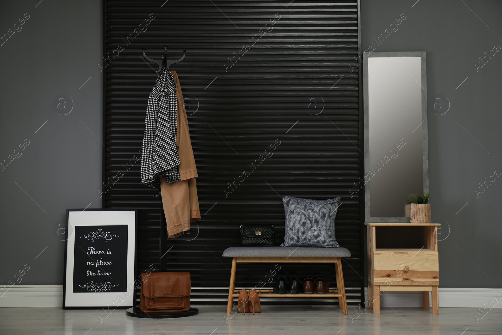 Photo of Hallway interior with modern furniture, mirror and clothes