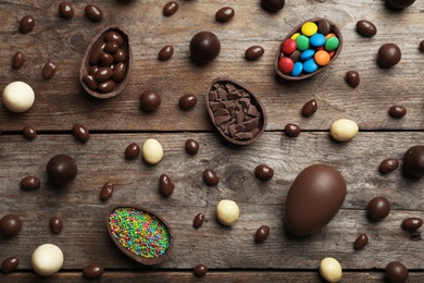 Photo of Flat lay composition with chocolate Easter eggs on wooden background