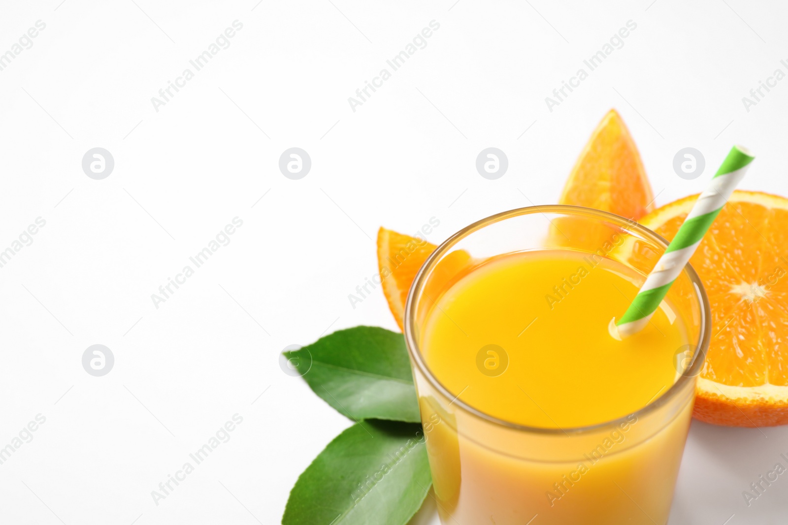 Photo of Glass of orange juice and fresh fruits on white background, closeup