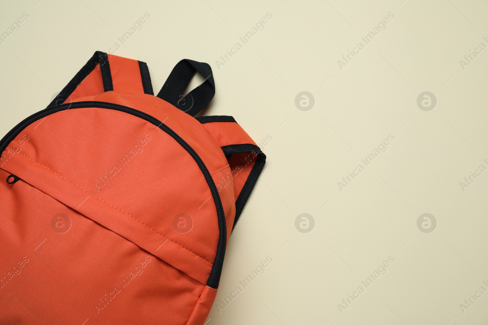 Photo of Stylish orange backpack on light background, top view. Space for text