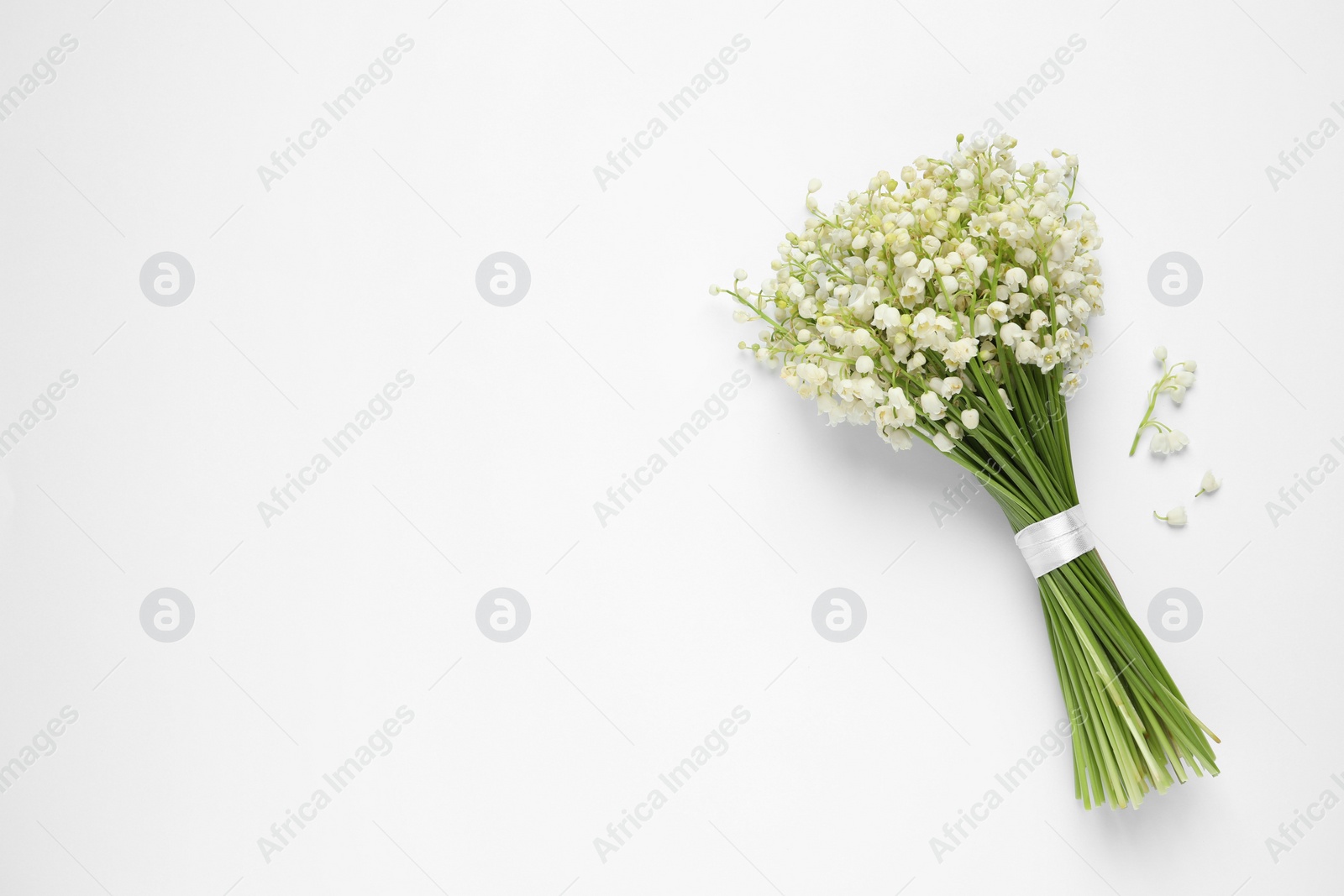Photo of Beautiful lily of the valley bouquet on white background, top view