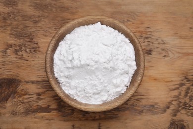 Photo of Bowl of natural starch on wooden table, top view