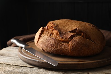 Photo of Freshly baked sourdough bread on wooden table