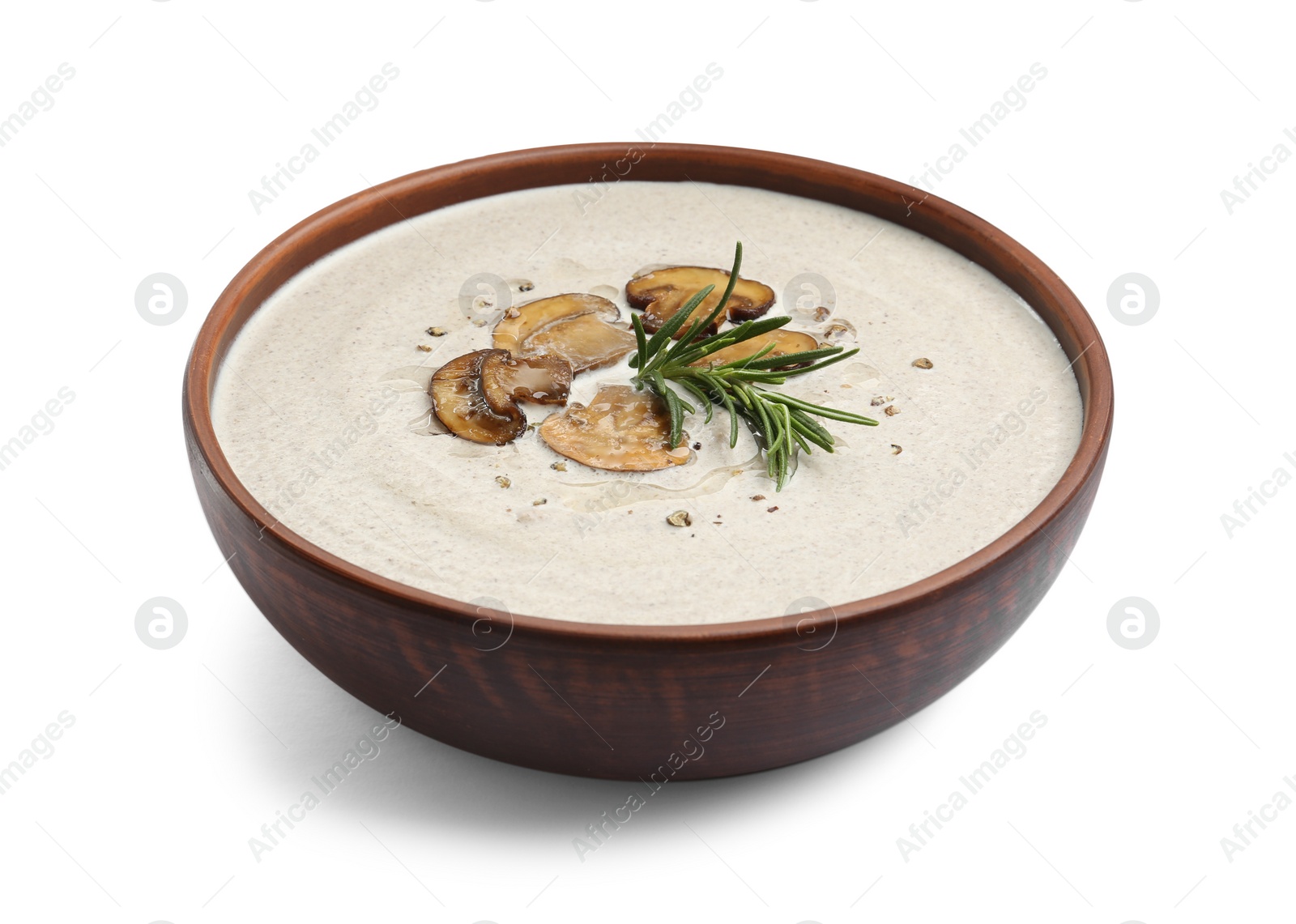 Photo of Fresh homemade mushroom soup in ceramic bowl isolated on white